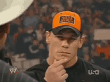 a man wearing an orange hat that says world heavyweight on it