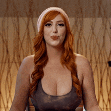 a woman with red hair wearing a pink hat