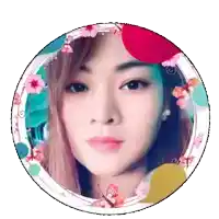 a woman 's face is in a circle with flowers and butterflies around it