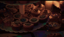 a display of cupcakes with glow in the dark eyes and spiders