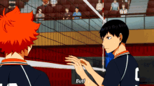 a volleyball player with the letter c on his jersey is talking to another player