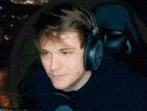 a man wearing headphones is sitting in a chair .