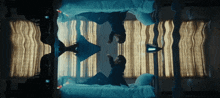 a person is laying on a bed with their reflection in the mirror
