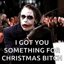 the joker from the movie the dark knight is holding a knife and says `` i got you something for christmas bitch ''