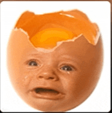 a broken egg with a baby 's face in it