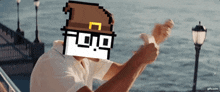 a man giving a thumbs up with a pixelated hat on his head