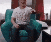 a man is sitting in a chair wearing a life full shirt