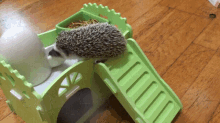 a small hedgehog is sitting on top of a green castle .
