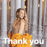 a woman in a gold dress is standing in front of columns and the words thank you are below her