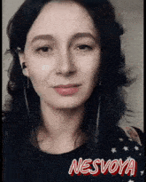 a woman is wearing headphones and the name nesvoya is on her shirt