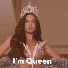 a woman wearing a crown and a dress says " i 'm queen "