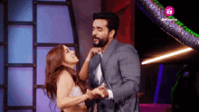 a man and a woman are dancing in front of a sign that says " live cinema "