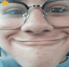 a close up of a person 's face with glasses and a star on it .