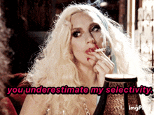a blonde woman smoking a cigarette with the words you underestimate my selectivity