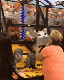 a woman wearing a cat mask is playing a game