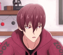 a close up of a person wearing a red hoodie with zoo on the sleeves