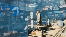 a man stands on a balcony in front of a sign that says ' tengu '