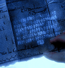 a person is writing on a piece of paper that says " the desolation of sinagus "