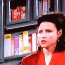 a woman is standing in front of a shelf of cereal boxes .