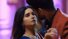 a man and a woman are dancing together and the woman is looking at the man 's face .