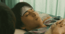 a man with a bandage on his head is laying in a hospital bed