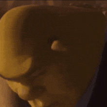 a close up of a man 's face with white hair and red eyes