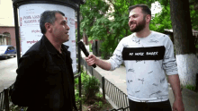a man wearing a shirt that says no more anger is being interviewed