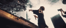 a person wearing a black shirt that says ch