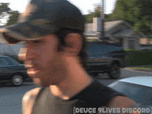 a blurry picture of a man wearing a hat with the words deuce 9 lives discord