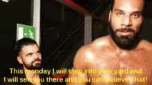 a shirtless man with a beard is standing next to another man with a green exit sign .