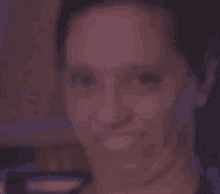 a woman is smiling and making a funny face with her mouth open .