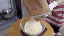 a bag of premium nuts is poured into a glass bowl