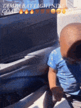 a baby sitting in the back seat of a car with the words tampa bay lightning goal written on the side