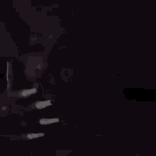 a dark background with a few spots of light on it