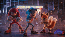 sonic the hedgehog , knuckles , and tails are standing next to each other in a video game .