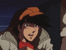 a man in a hat is standing next to a boy in a jacket
