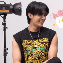 a man wearing a black shirt that says after dark smiles in front of a camera