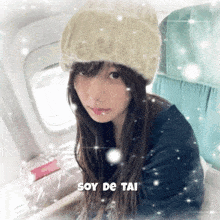 a woman wearing a knitted hat with soy de tai written on the bottom