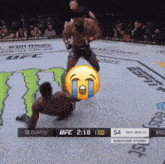 a screenshot of a ufc fight with a crying emoji on the screen