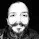 it is a black and white photo of a man with a beard .