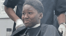 a man getting his hair cut by a barber