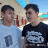 two young men are standing next to each other and one has a california t-shirt on