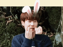 a young man wearing bunny ears on his head
