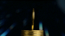a stack of gold coins with the words btc moneytalks behind it