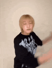 a blurry picture of a person wearing a black shirt and dancing .