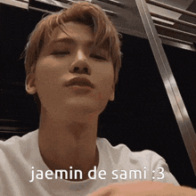 a close up of a man 's face with the words jaemin de sami : 3 written on it