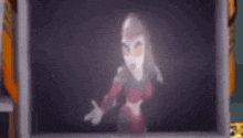 a blurry picture of a woman in a mask standing in front of a television screen .