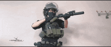 a person holding a gun in front of a wall that says aocsmw.com.ua