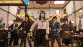 a group of people are standing in a room and dancing together