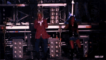 a man and a woman are dancing on a stage with rbd.gr written in the lower right corner